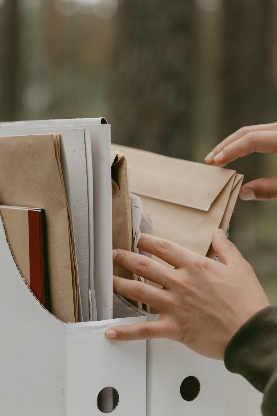 A Person's Hands Touching Folders